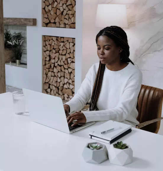 Woman in white long sleeve shirt with laptop